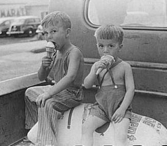Farm boys eating ice-cream cones. Washin